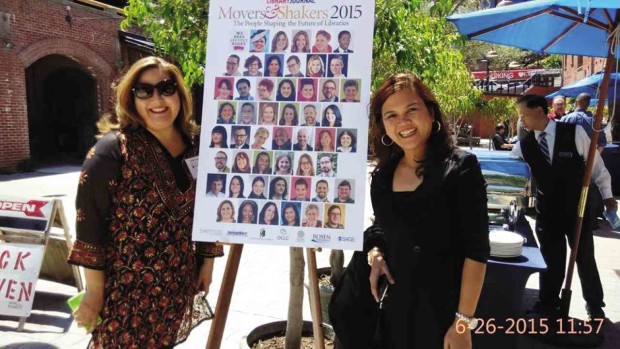 LIBRARIAN Lorna Equia (right) poses with a friend beside a poster with the names and photos of librarians who were given the 2015 Movers and Shakers awards. CONTRIBUTED PHOTO