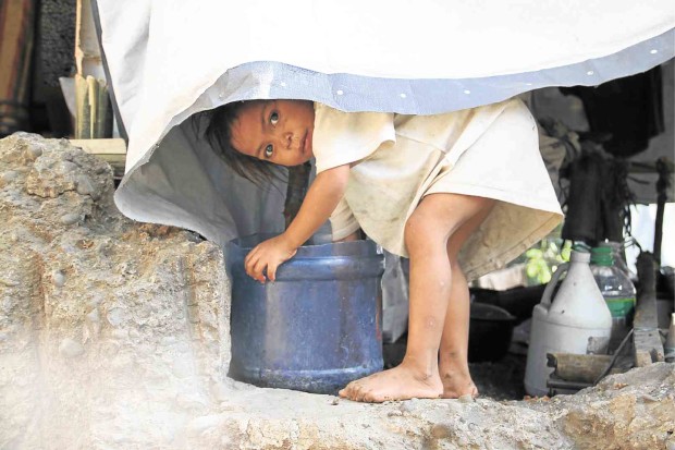 LIFE in a shelter is tough for this “lumad” child, who plays with a water container at the Haran compound of United Church of Christ in the Philippines in Davao City where she and hundreds of other lumad sought refuge after fleeing heavy military presence in their community.   DENNIS JAY SANTOS/INQUIRER MINDANAO