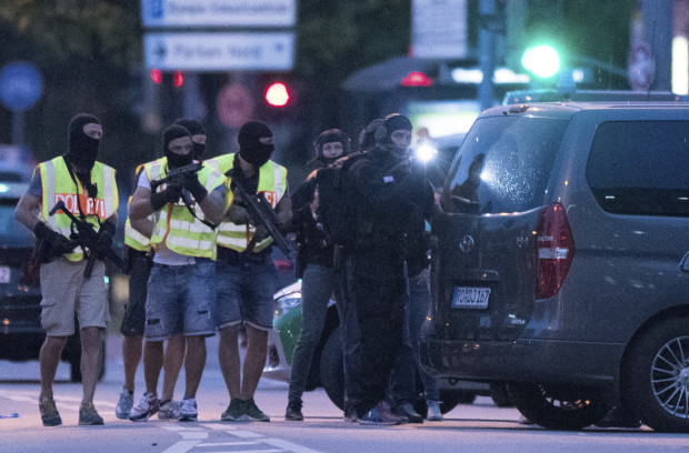 Special police forces prepare to search a neighbouring shopping centre outside the Olympia mall in Munich, southern Germany, Friday, July 22, 2016 after several people have been killed in a shooting. (AP Photo/Sebastian Widmann)