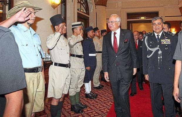 History at a glance: Najib accompanied by InspectorGeneral of Police Tan Sri Khalid Abu Bakar being greeted by police personnel clad in uniforms worn by the force through the ages at the Aseanapol conference at the Marriot Hotel in Putrajaya. The Star/Asia News Network