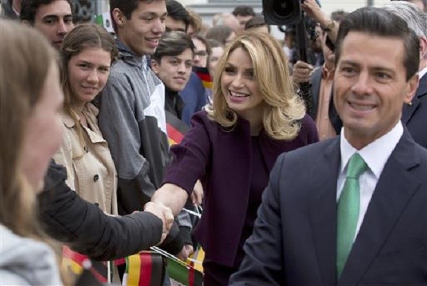 In this April 11, 2016 file photo, Mexico's President Enrique Pena Nieto, right, and his wife Angelica Rivera de Pena greet students as they arrive to meet with Germany's President Joachim Gauck at Bellevue Palace in Berlin, Germany. Pena Nieto apologized on Monday, July 18, 2016 for a 2014 scandal involving a mansion his wife bought from a firm that won lucrative contracts with his administration. AP FILE PHOTO