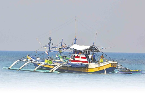 CREWMEN of a fishing boat relax after a trip to the West Philippine Sea.      WILLIE LOMIBAO/INQUIRER NORTHERN LUZON