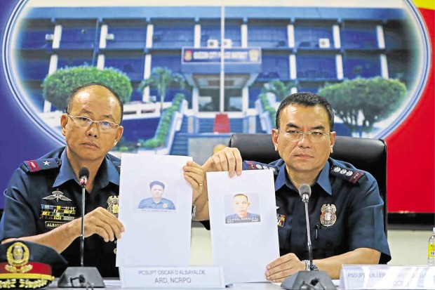 NCRPO director Chief Supt. Oscar Albayalde (left) and QCPD chief Senior Supt. Guillermo Lorenzo Eleazar announce the arrest of  Quezon City policemen PO1 Edgar Allan Co and PO1 Ronald Clarin for extortion. KIMBERLY DELA CRUZ