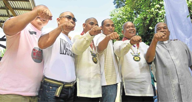 SOME of the newly shaved and newly sworn in members of the Iligan City council with Vice Mayor Jemar Vera Cruz, a Catholic priest who is demanding freedom for Iligan Mayor Celso Regencia JIGGER J. JERUSALEM/INQUIRER MINDANAO