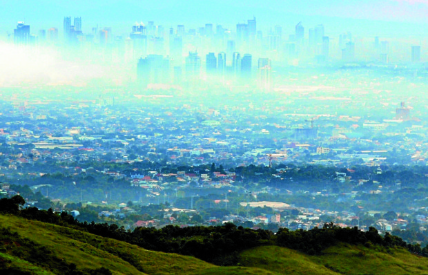 As seen from San Mateo, Rizal province, thick smog — a toxic mix of vehicle exhaust, emissions from factories and other sources of air pollution — covers vast stretches of Metro Manila and environs. 