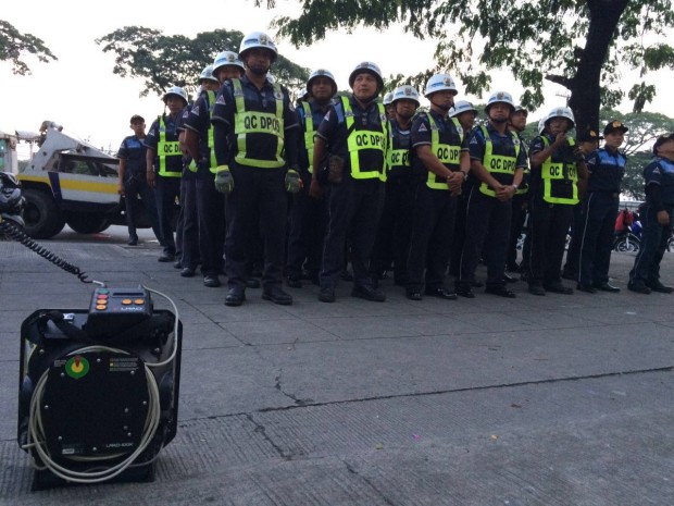 Quezon City Dept. of Public Order and Safety personnel prepare to deploy at Commonwealth Ave. prior to President Rodrigo Duterte's State of the Nation Address. INQUIRER.net/GRIG MONTEGRANDE 