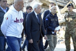 Italy's President Sergio Mattarella (C) walks past an Italian soldiers as he visits with mayor of Amatrice Sergio Pirozzi (L) the damaged central Italian village of Amatrice on August 26, 2016, three days after a 6.2-magnitude earthquake struck the region killing  some 281 people. Italy prepared for an emotional day of mourning on August 27, 2016 with flags across the country to fly at half mast in honour of the 281 victims of a devastating earthquake. Grieving families began burying their dead on August 26 as rescue workers combing the rubble said they had found no new survivors in the remote mountain villages in central Italy blitzed by August 24's powerful pre-dawn quake.  / AFP PHOTO / ANDREAS SOLARO