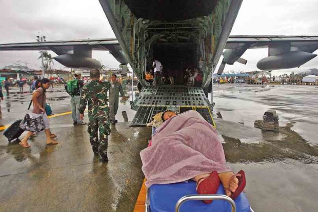 A WOMAN seeking medical attention waits to board a military C-130 plane as people were evacuated in Tacloban City after Supertyphoon “Yolanda” struck in 2013. The Philippine Air Force’s smaller aircraft, like helicopters, will again be tapped to bring patients in Southern Tagalog’s island provinces to hospitals in Metro Manila through a partnership with the Department of Health. RAFFY LERMA