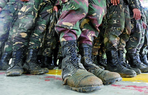 WAITING FOR DIGONG Bored Army Scout Rangers in theirmuddied and worn out boots await the arrival of President Duterte at Camp Tecson in San Miguel, Bulacan province, only to be told the commander in chief could not come because of bad weather. PHOTOS BY JOAN BONDOC