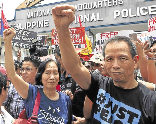 NOW IT’S OFF TO OSLO Communist Party of the Philippines leader Benito Tiamzon and his wife, Wilma, raise clenched fists as they walk out of police detention on Friday  to join rebel negotiators in peace talks in Norway next week. NIÑO JESUS ORBETA