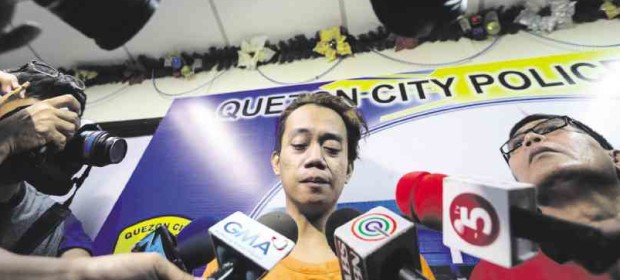 CONFESSION Jeffrey Guarin turns himself in to the Quezon City police on Wednesday, admitting the gruesome killing of a nurse whom he also tried to rob inside a boarding house on Aug. 20. He later tested positive for drug use. LYN RILLON