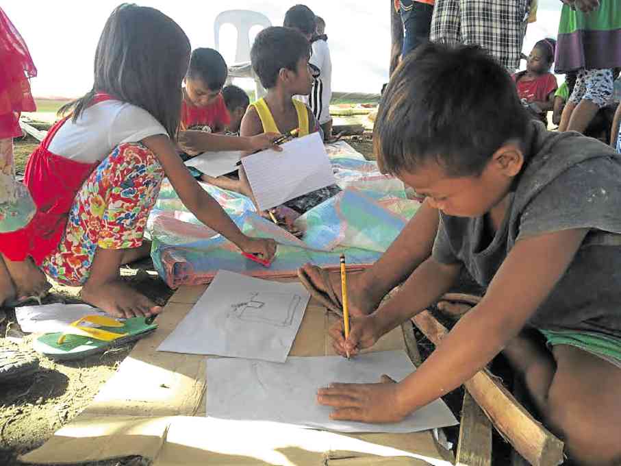 “LUMAD” children continue attending school in makeshift tents at the sports complex in Tandag City in Surigao del Sur province, where their families have been staying since leaving their communities in Lianga town last year. NICO ALCONABA / Inquirer Mindanao