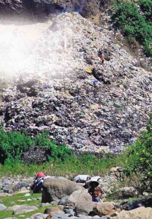 MOUNTAIN Province capital Bontoc shut down this open dump (shown in this 2009 photograph), after Kalinga province complained that the facility was polluting the Chico River. EV ESPIRITU 