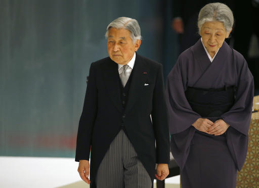 FILE - In this Aug. 15, 2015 file photo, Japan's Emperor Akihito, accompanied by Empress Michiko, leaves after delivering his remarks during a memorial service at Nippon Budokan martial arts hall in Tokyo. Akihito still works, though his aides have shifted some of his duties to Crown Prince Naruhito,  the elder of his two sons and most likely successor. Yet, Akihito has referred to his old age in recent years, admitting to making small mistakes at ceremonies. During the Aug. 15, 2015, anniversary of the end of World War II, Akihito started reading a statement when he was supposed to observe a moment of silence. (AP Photo/Shizuo Kambayashi, File)