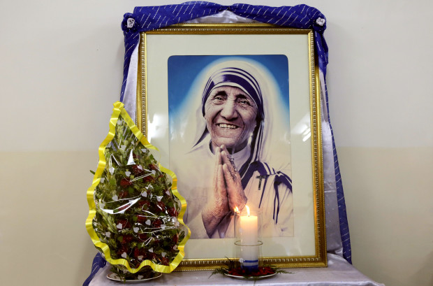 A portrait of late Mother Teresa is placed near her tomb at the Missionaries of Charity Mother house in Kolkata, India, Aug. 26, 2016. Mother Teresa will be made a saint on Sept. 4, 2016. Born Agnes Gonxha Bojaxhiu on Aug. 26, 1910, in Skopje, Macedonia, Mother Teresa joined the Loreto order of nuns in 1928. In 1946, while traveling by train from Calcutta to Darjeeling, she was inspired to found the Missionaries of Charity order. (AP Photo/Bikas Das)