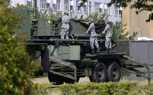 In this June 21, 2016 file photo, Japan Self-Defense Force members set up a PAC-3 Patriot missile unit deployed in case of a North Korean rocket launch at the Defense Ministry in Tokyo.  Japan has called North Korea's nuclear and missile development a "grave and imminent threat" to the region and international security, and criticized China's increasingly assertive military action in its annual defense report.  The report, approved Tuesday, Aug. 2, 2016,  by the Cabinet, comes as Prime Minister Shinzo Abe's government pushes for Japan to take on greater military roles abroad.  AP FILE PHOTO 