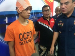 Suspect Jeffrey Guarin (in orange shirt) has confessed to stabbing to death St. Luke's Medical Center nurse September Ann Paz. Guarin surrenders to the QCPD and faces the QCPD chief, Senior Supt. Guillermo Lorenzo Eleazar. (PHOTO BY MARICAR BRIZUELA / INQUIRER)