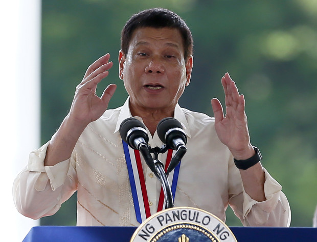 Philippine President Rodrigo Duterte gestures while addressing guests following a wreath-laying ceremony in observance of National Heroes Day, Monday, Aug. 29, 2016 at the Heroes Cemetery in suburban Taguig city, east of Manila, Philippines. In his address, Duterte announced a 2 million pesos ($43,000) bounty for each police officer who are protecting drug lords in his unrelenting anti-illegal drugs campaign that saw close to 2,000 killed since he took office June 30. (AP Photo/Bullit Marquez)