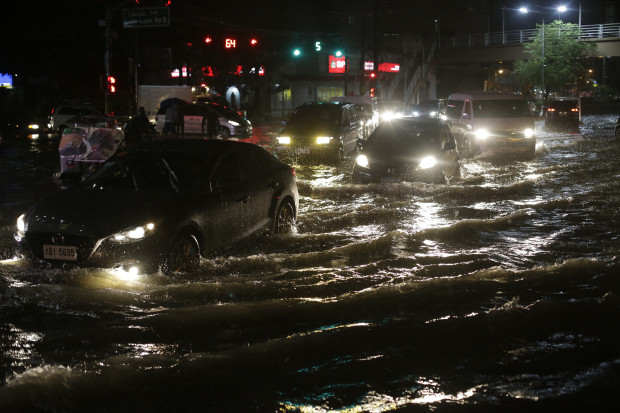 Vehicles navigate a flood-prone street as heavy rain pours in Manila, Philippines on Friday, Aug. 12, 2016. Heavy rains snarled traffic around Metropolitan Manila and stranded thousands of commuters. (AP Photo/Aaron Favila)
