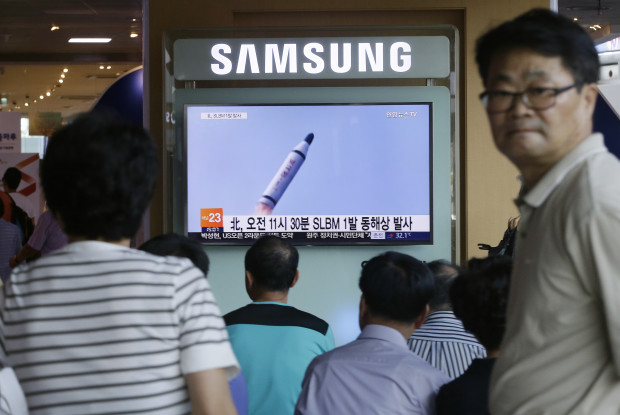 People watch a TV news program showing a file footage of North Korea's ballistic missile that the North claimed to have launched from underwater, at Seoul Railway station in Seoul, South Korea, Saturday, July 9, 2016. North Korea on Saturday fired what appeared to be submarine-launched ballistic missile off its eastern coast, the U.S. and South Korea said, in the latest test that's part of efforts by the North to advance technology capable of delivering nuclear warheads. (AP Photo/Ahn Young-joon)