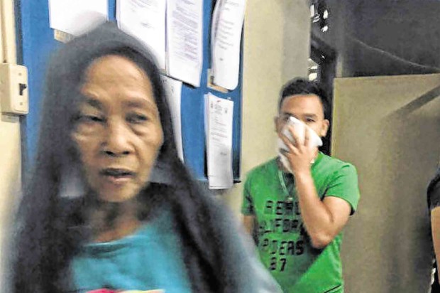 THE MOTHER of drug lord “Barok” Alvaro at the Danao police station where she warned policemen she can have them killed by her son.  PHOTOS BY TONEE DESPOJO/CEBU DAILY NEWS