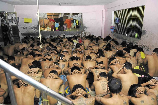 INMATES at the Cebu provincial jail are ordered to strip down and squat during a raid that yielded drugs and other contraband.  CHRISTIAN MANINGO/CEBU DAILY NEWS 
