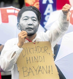 A PROTESTER wearing a Marcos mask makes public his sentiments against the ex-President. Eloisa Lopez