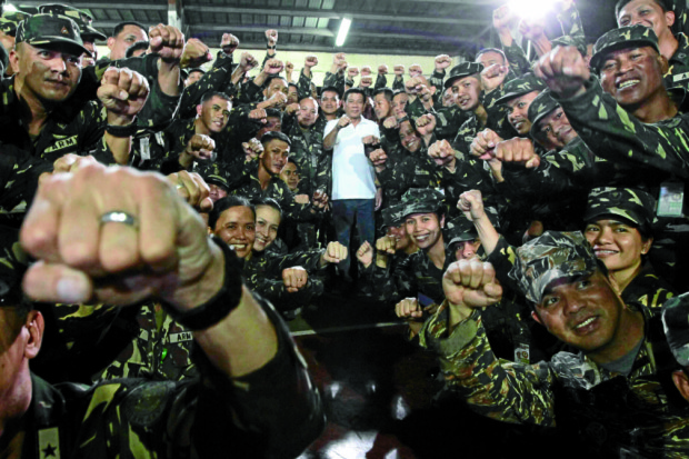 NOCOUP D’ETAT, PLEASE President Duterte is making the rounds of military camps to introduce himself to the troops and to urge them not to mount a putsch against him. He jokingly tells soldiers at the Armed Forces of the Philippines Medical Center in Quezon City that they can just tell him to leave office and he will do so. ROBINSON NIÑAL/PPD