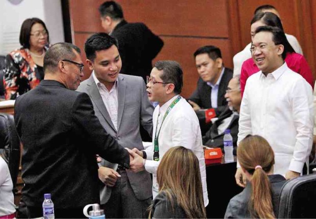 Quezon City councilors surround Hero Bautista after his privilege speech—his first time to address rumors he tested positive for drugs.  RICHARD A. REYES
