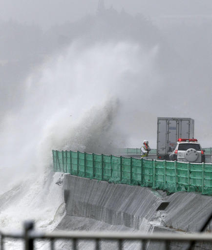 Waves crash against a coastal road in Minamisanriku, Miyagi prefecture, northeastern Japan, Tuesday, Aug. 30, 2016. A typhoon is about to barrel into northern Japan, threatening to bring floods to an area still recovering from the 2011 tsunami. Typhoon Lionrock has already paralyzed traffic, caused blackouts and prompted officials to urge residents to evacuate.(Hironori Asakawa/Kyodo News via AP)