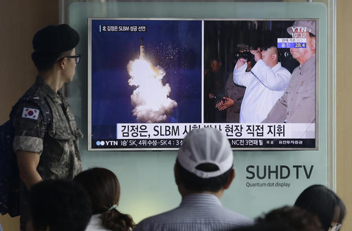 FILE - In this Thursday, Aug. 25, 2016, file photo, a South Korean army soldier watches a TV news program showing images published in North Korea's Rodong Sinmun newspaper of North Korea's ballistic missile believed to have been launched from underwater and North Korean leader Kim Jong-un, at Seoul Railway station in Seoul, South Korea. The UN Security Council is strongly condemning four North Korean ballistic missile launches in July and August, calling them "grave violations" of a ban on all ballistic missile activity. A press statement approved by all 15 members Friday night deplored the fact that the North's ballistic missile activities are contributing to its development of nuclear weapon delivery systems and increasing tensions. AP FILE PHOTO