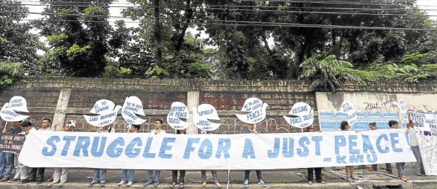 MILITANT groups, in a rally in Quezon City in July, display a streamer expressing support for peace talks between the government and communist rebels. LYN RILLON