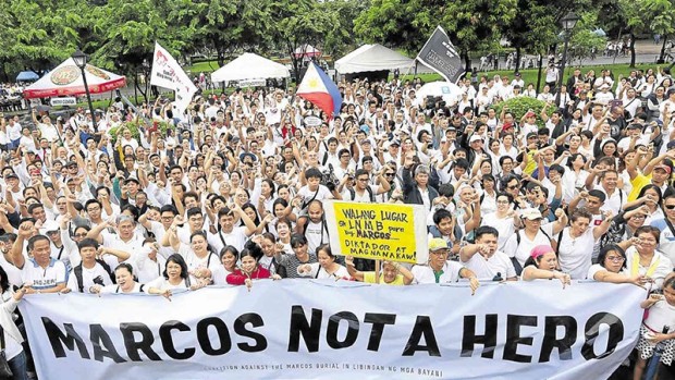 KEEP HIM IN BATAC Hundreds of people gather at the Lapu-Lapu monument in Rizal Park, Manila, on Sunday to protest the burial of President Ferdinand Marcos at Libingan ng mga Bayani. President Duterte is determined to allow a state burial for the late dictator. MARIANNE BERMUDEZ