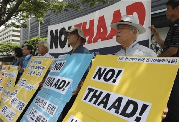 South Korean protesters hold signs during a rally denouncing a plan to deploy an advanced US missile defense system called Terminal High-Altitude Area Defense, or THAAD, near US Embassy in Seoul, South Korea, Tuesday, July 19, 2016. North Korea on Tuesday fired three ballistic missiles into its eastern sea in an apparent protest of South Korea's decision to allow the deployment of an advanced US missile defense system in the country, Seoul officials said. The letters read "Stop, to deploy the Terminal High-Altitude Area Defense, or THAAD." AP 