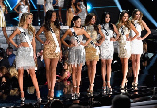 LAS VEGAS, NV - DECEMBER 20: (L-R) Miss USA 2015, Olivia Jordan, Miss France 2015, Flora Coquerel, Miss Philippines 2015, Pia Alonzo Wurtzbach, Miss Dominican Republic 2015, Clarissa Molina, Miss Indonesia 2015, Anindya Kusuma Putri, Miss Australia 2015, Monika Radulovic, and Miss Brazil 2015, Marthina Brandt, stand on stage after being named top 15 finalists during the 2015 Miss Universe Pageant at The Axis at Planet Hollywood Resort & Casino on December 20, 2015 in Las Vegas, Nevada.   Ethan Miller/Getty Images/AFP