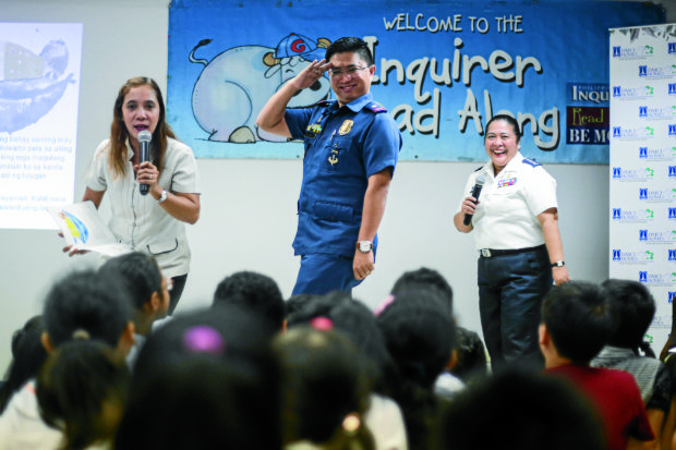 READ-ALONG/September, 17, 2016: 2016 Metrobank Foundation Outstanding Filipinos, Miss Rujealyn Cancino, a master teacher, Col. Jocelyn Turla, a Chief Surgeon at the Philippine Navy and Sir Ryan Manongdo, a police Chief Inspector salutes while telling a story to the students from different schools during the second part of the event. They are the story-tellers of Inquirer's Read-Along for the month of September. INQUIRER PHOTO/John Paul R. Autor