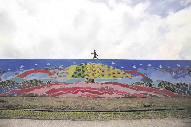 REMEMBERING  The pain of remembering the devastation wrought by Typhoon “Reming” on Albay province 10 years ago has been eased by images of hope and strength in a mural painted by survivors.  MARK ALVIC ESPLANA