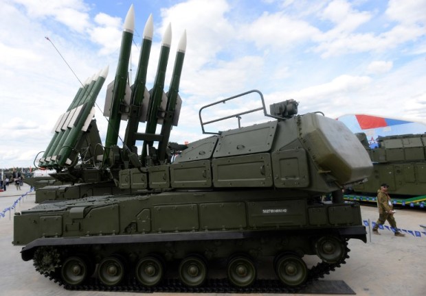 A visitor walks past a Russian self-propelled surface-to-air missile systems BUK-M2E during the 'Army-2015' international military forum in Kubinka, outside Moscow, on June 17, 2015. AFP PHOTO / VASILY MAXIMOV / AFP PHOTO / VASILY MAXIMOV