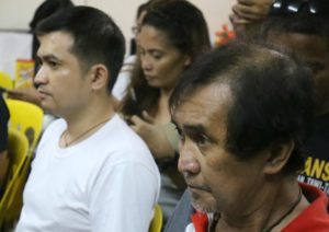 Cerilo Alcala (right) and son, Sajid Alcala (in white shirt), both related to former agriculture secretary Proceso Alcala, appear at a police station, on Aug. 14, 2016, to respond to allegations on their involvement in drugs. (FILE PHOTO BY DELFIN T. MALLARI/ INQUIRER SOUTHERN LUZON)
