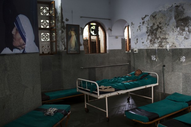 An inmate lays on a bed at 'Nirmal Hriday Kalighat, Mother Teresa's home for the dying & destitute in Kolkata, India, Friday, Sept. 2, 2016. Missionaries of Charity, the order set up by Mother Teresa has hundreds of shelters that care for some of the world's neediest, people she described as the "poorest of the poor." (AP Photo/Bernat Armangue)