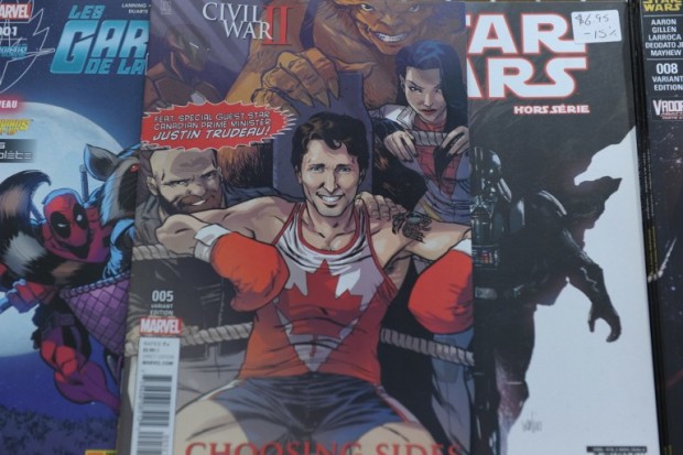 The cover of US publisher Marvel's comic book, featuring Canadian Prime Minister Justin Trudeau as a super hero in front of a newstand in Montreal, Canada on August 31, 2016.  Canadian Prime Minister Justin Trudeau takes the role of a superhero in a comic book by US publisher Marvel released on newsstands August 31 in Canada. Trudeau appears smiling in a corner of a boxing ring on the cover of the comic book, a limited edition in English of the series "Civil War II: Choosing Sides" wearing a maple leaf shirt.  / AFP PHOTO / Marc BRAIBANT / TO GO WITH AFP STORY BY MARC BRAIBANT