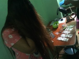 Mary Rose Noscal hides her face after being caught with sachets of shabu in her Quezon City home during a raid by QC police and the Philippine Drug Enforcement Agency, on Sept. 1, 2016 (Photo by MARICAR BRIZUELA / INQUIRER)