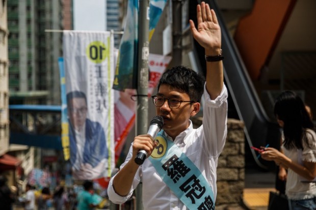 Nathan Law, 23, a leader of the 2014 pro-democracy rallies, campaigns for his political party Demosisto party during the Legislative Council election in Hong Kong on September 4, 2016. Young Hong Kong independence activists calling for a complete break from China stood in major elections for the first time on September 4, the biggest vote since 2014 pro-democracy rallies.  / AFP PHOTO / Anthony WALLACE