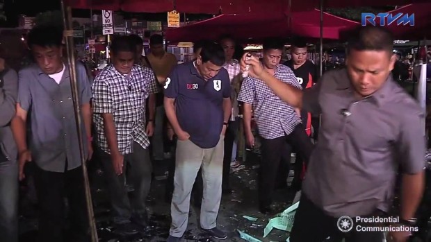 President Rodrigo Duterte stares at the ground of the Davao City night market where 14 were killed and around 60 were wounded on Sept. 2, 2016. (SCREENGRAB OF RTVM VIDEO/ Courtesy of Presidential Communications)