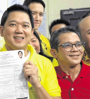 Quezon City Mayor Herbert Bautista (left) and his brother, Councilor Hero Bautista (in red shirt). (INQUIRER FILE PHOTO)