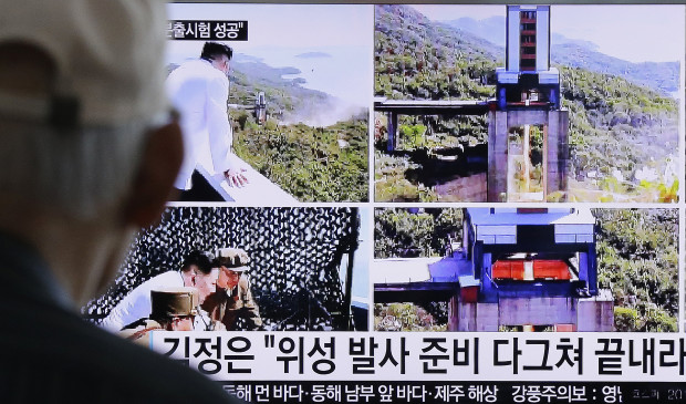 A man watches a TV news showing images that North Korea's Rodong Sinmun newspaper reports of the ground test of a high-powered engine of a carrier rocket and North Korean leader Kim Jong Un at the country's Sohae Space Center, at Seoul Railway station in Seoul, South Korea, Tuesday, Sept. 20, 2016. North Korean leader Kim has overseen a ground test of a new rocket engine and ordered a satellite launch preparation, state media said Tuesday, an indication the country might soon conduct a prohibited long-range rocket launch. The letters read "Kim Jong Un directed the ground test of a high-powered engine of a carrier rocket for a geo-stationary satellite." (AP Photo/Ahn Young-joon)