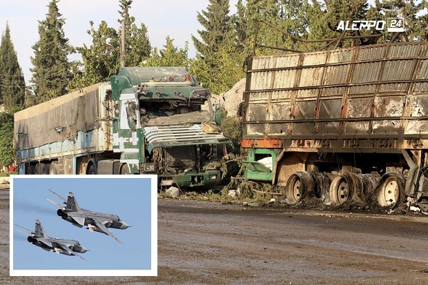 This image provided by the Syrian anti-government group Aleppo 24 news, shows damaged trucks carrying aid, in Aleppo, Syria, Tuesday, Sept. 20, 2016. A U.N. humanitarian aid convoy in Syria was hit by airstrikes Monday as the Syrian military declared that a U.S.-Russian brokered cease-fire had failed. The US says it is holding Russia responsible for the attack, saying two Russian SU-24 figther jets were in the area during the attack. AP