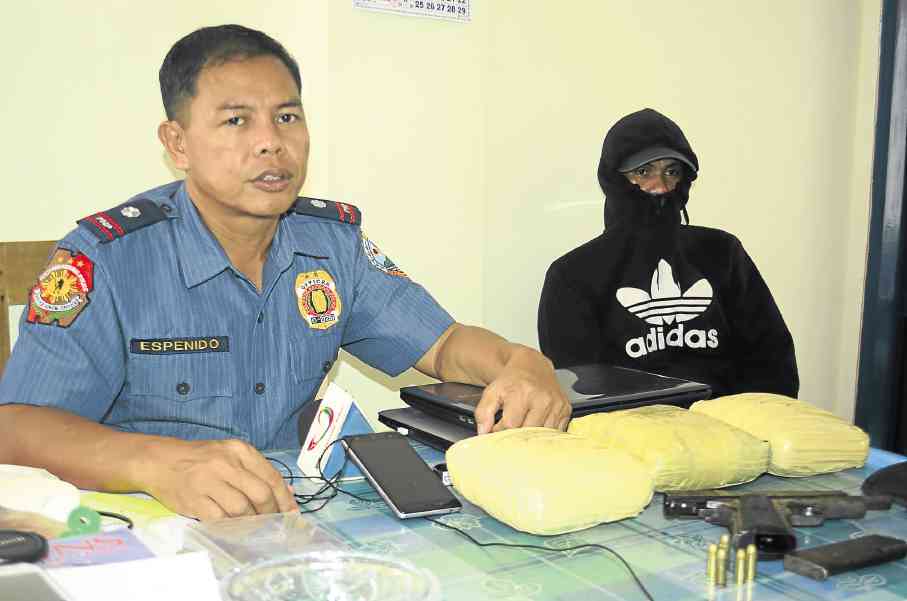 KERWIN'S MAN Chief Insp. Jove Espenido, police chief of Albuera town in Leyte province, says Max Miro (right), the top aide of suspected drug lord Kerwin Espinosa, led policemen to a spot where he hid a stash of “shabu” (methamphetamine hydrochloride, shown in foreground), worth P24 million, on orders of Espinosa. ROBERT DEJON/Inquirer Visayas