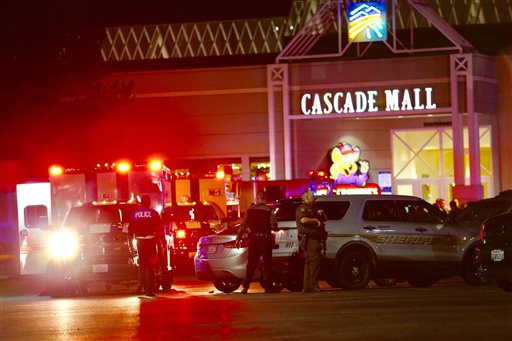 Law enforcement officers work at the crime scene outside of Cascade Mall in Burlington, Wash., where several people were fatally shot on Friday, Sept. 23, 2016. Authorities in Washington State say several people have been killed during a shooting at the mall north of Seattle and that at least one suspect remains at large. Sgt. Mark Francis says authorities are searching for a man wearing gray who was last seen walking toward Interstate 5 from the mall. (Dean Rutz/The Seattle Times via AP)