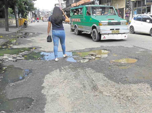 ROAD CONGESTION in Metro Cebu is aggravated by the state of disrepair of some of the city’s streets, like Sanciangko shown here, where potholes turn walking or driving into a game akin to Minecraft.    LITO TECSON/CEBU DAILY NEWS